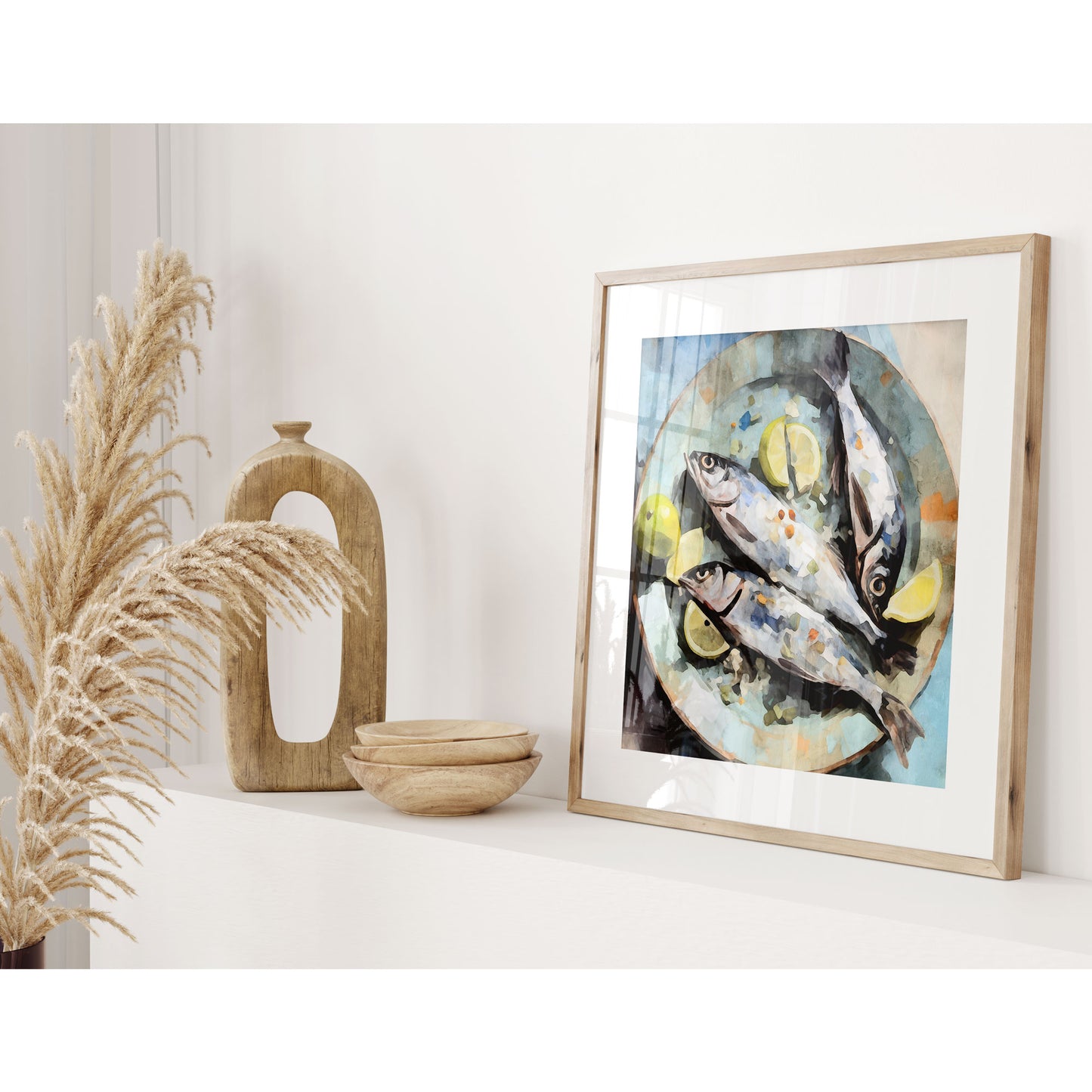 Framed watercolor painting of three fish with lemon slices on a blue plate on a shelf, accompanied by decorative wooden objects and dried grasses in a light-filled room.
