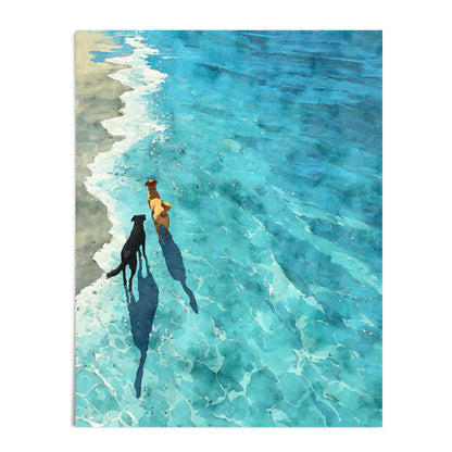 Art print of two dogs—one black and one golden—walking side by side along a sunlit shoreline. Their long shadows stretch across the rippling turquoise water in this watercolor-style composition, evoking a serene and joyful coastal moment.