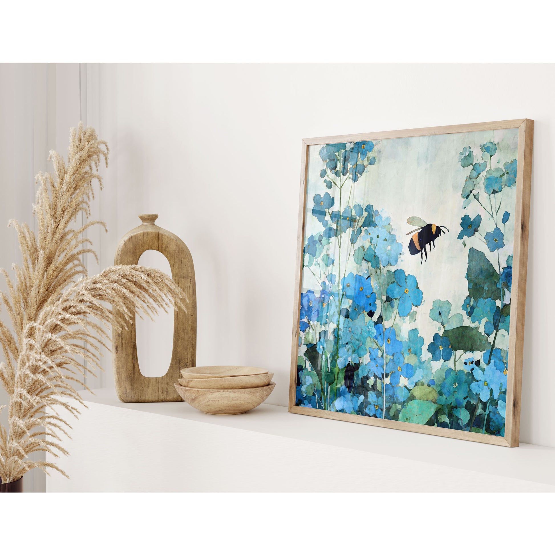 Framed artwork of a bee and flowers on a white surface with decorative elements.