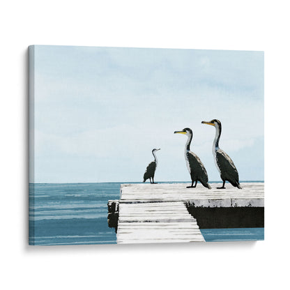 Canvas print of a minimalist illustration featuring three cormorants standing on a white wooden dock over a calm blue sea, set against a pale sky with soft clouds.