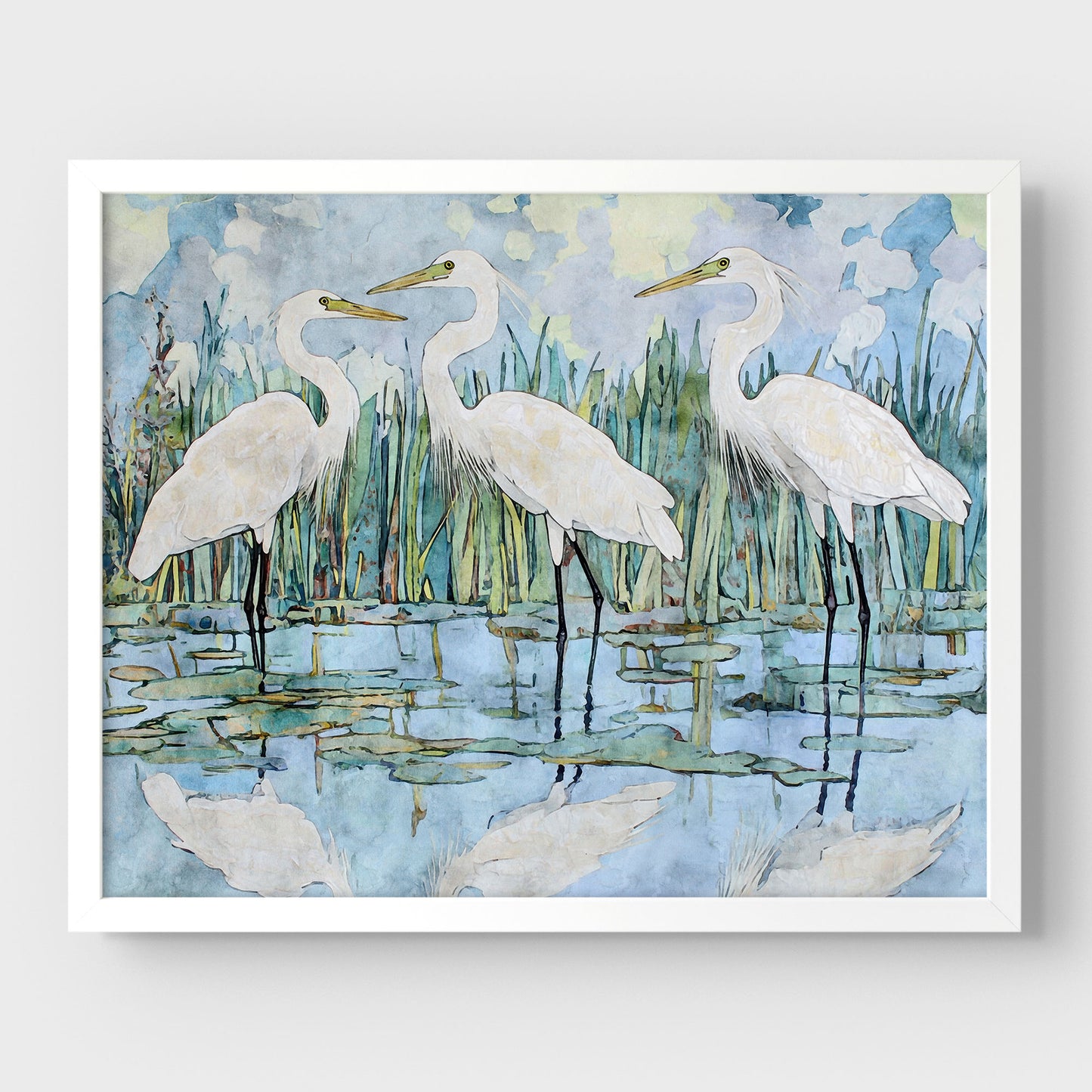 Framed artwork of three white herons in a marshy area with water and reeds.