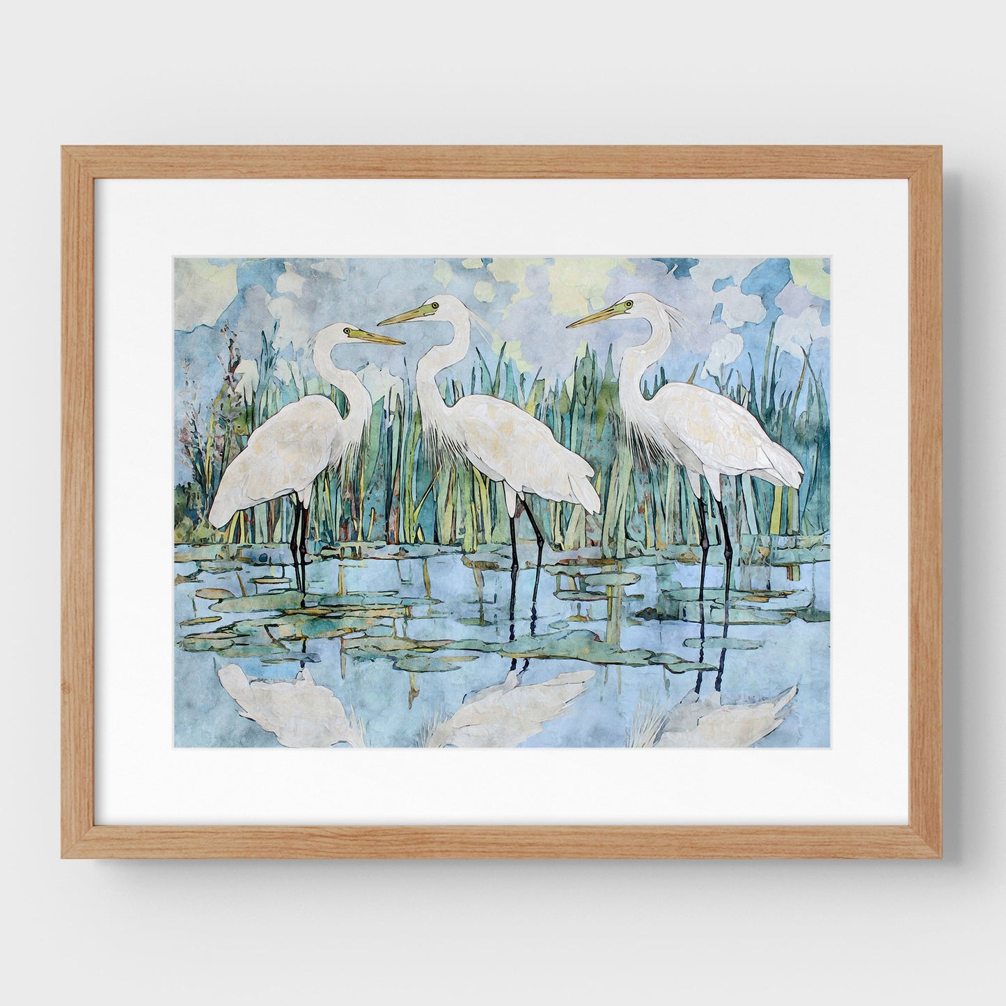 Framed artwork of three white birds in a natural setting with a wooden frame.