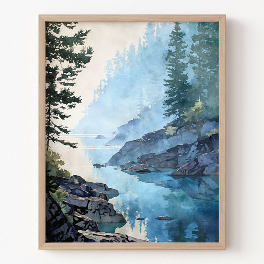 Framed artwork of a mountain landscape with a lake and trees on a white wall.