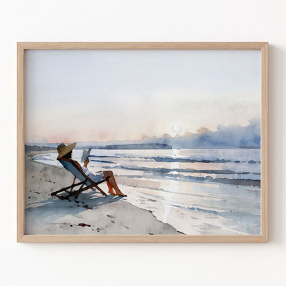 Framed artwork of a person sitting on a beach chair by a body of water.