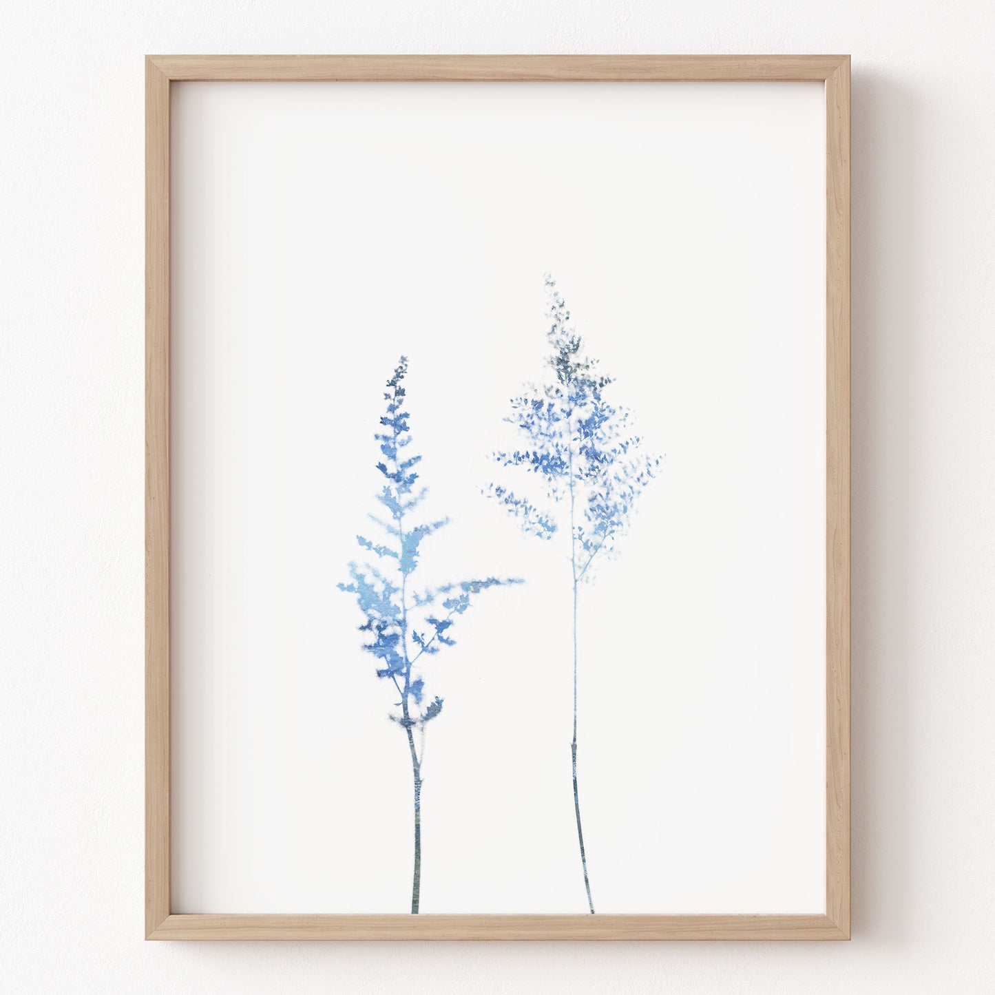 Framed artwork of blue floral branches on a white background