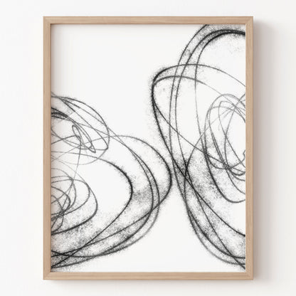 Framed abstract art print with black line drawings on a white background