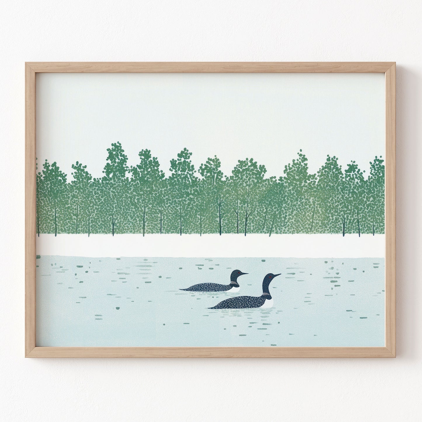 Framed artwork of two loons on a lake with a forest in the background