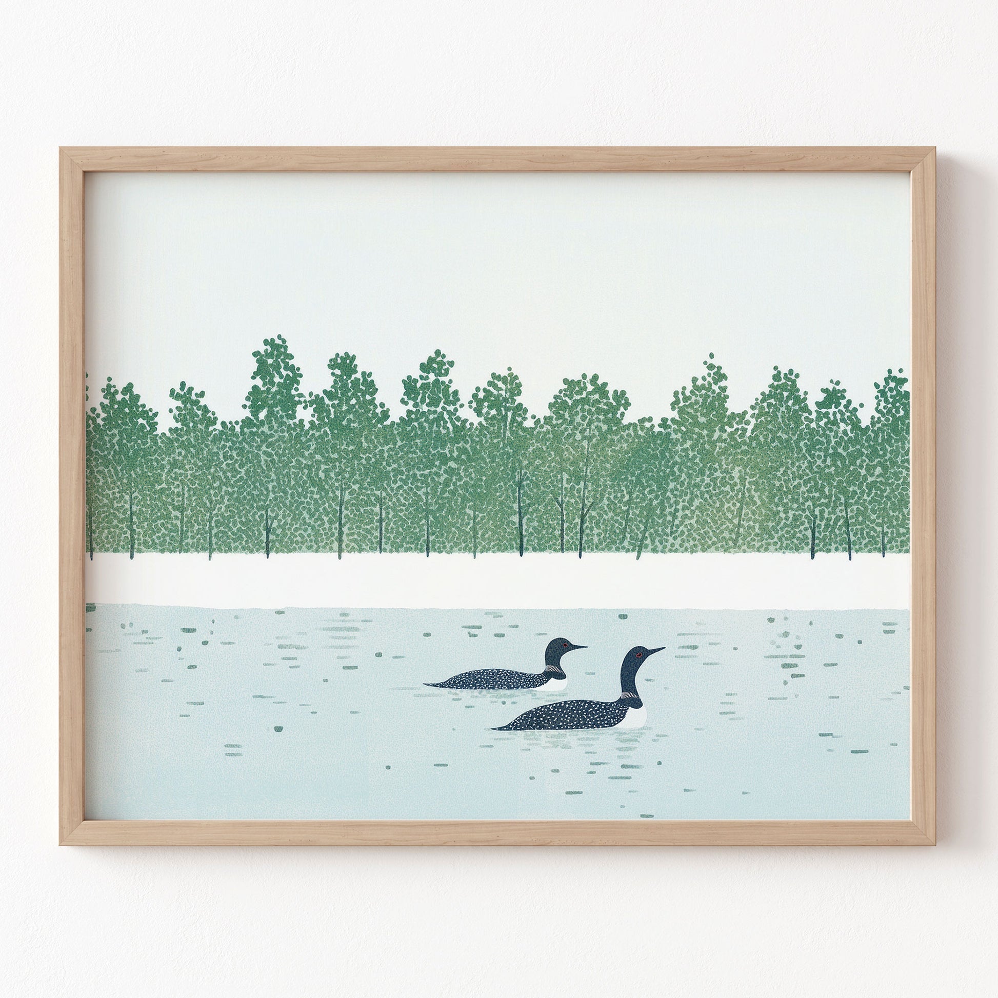 Framed artwork of two loons on a lake with a forest in the background