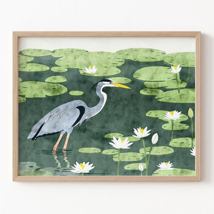 Framed artwork of a heron in a pond with lily pads and water lilies.