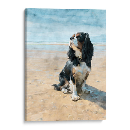 Canvas print of a tricolor King Charles spaniel on a beach with a blue sky.