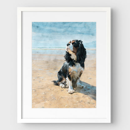 White framed artwork with a white mat of a tricolor King Charles spaniel on a beach with a watercolor background